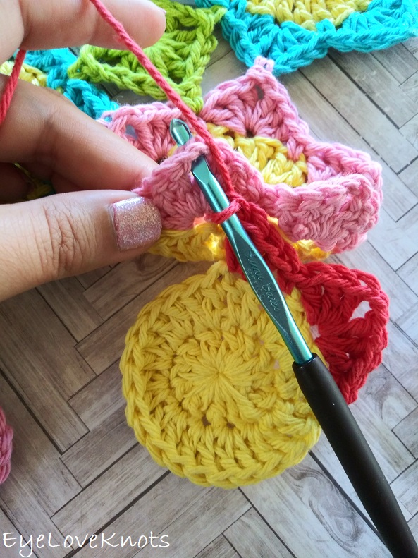 insert crochet hook into the previous flowers chain space from behind EyeLoveKnots