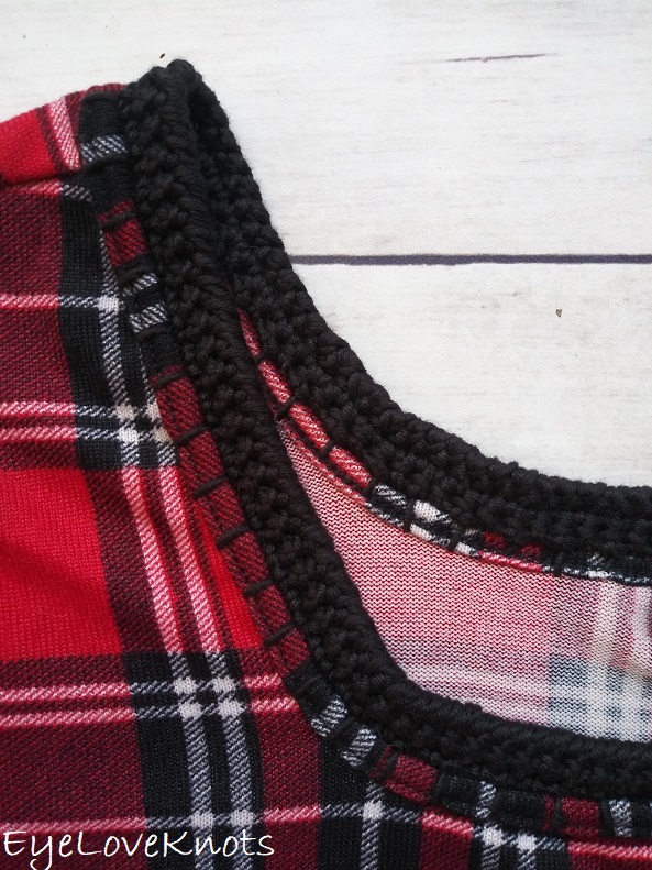 Close up of crocheted edging around neckline of plaid shirt