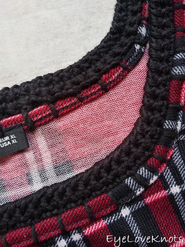 Close up of crocheted edging around neckline of plaid shirt