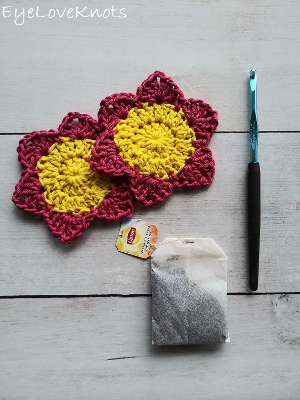 Two pink and yellow flowers, H8/5mm crochet hook and a Lipton tea bag, EyeLoveKnots