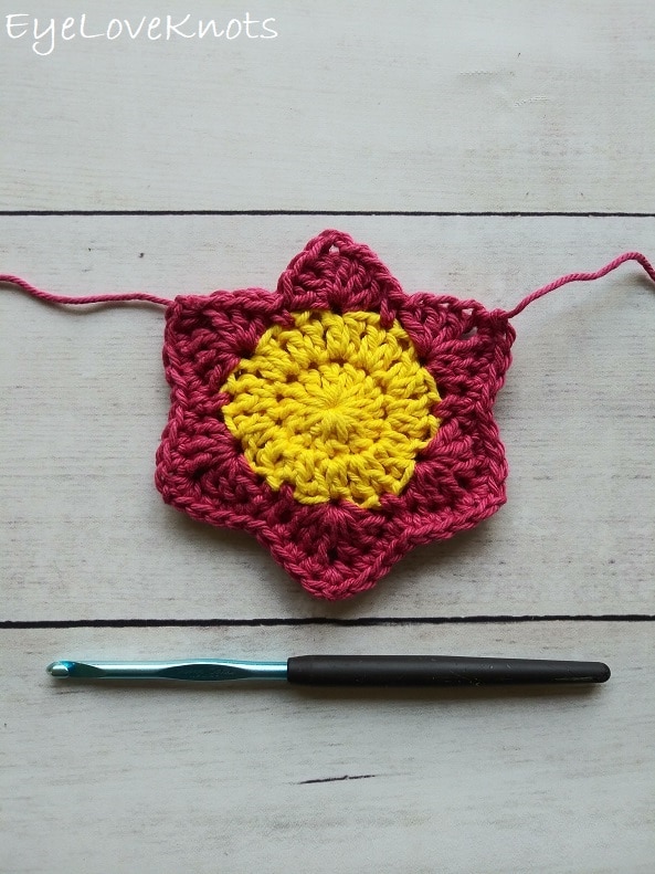 pink and yellow crocheted flower with finished joining edge and an H8/5mm crochet hook, EyeLoveKnots