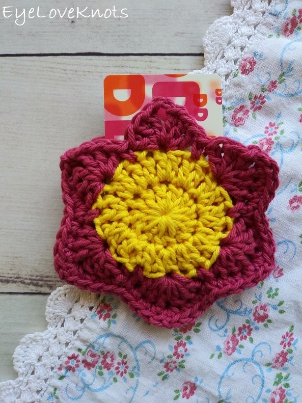 EyeLoveKnots, Lily's Floral Gift Card Holder on a floral table runner, Dunkin Donuts gift card holder, pink and yellow crocheted flower, crocheted gift card holder